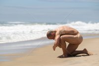 naked-man-kneeling-down-at-the-ocean.jpg